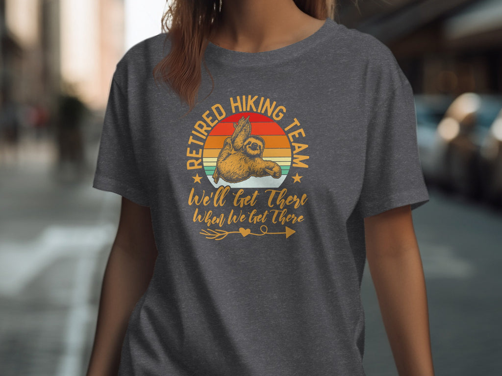 Dark grey t-shirt with a sloth graphic and text saying "Retired Hiking Team".