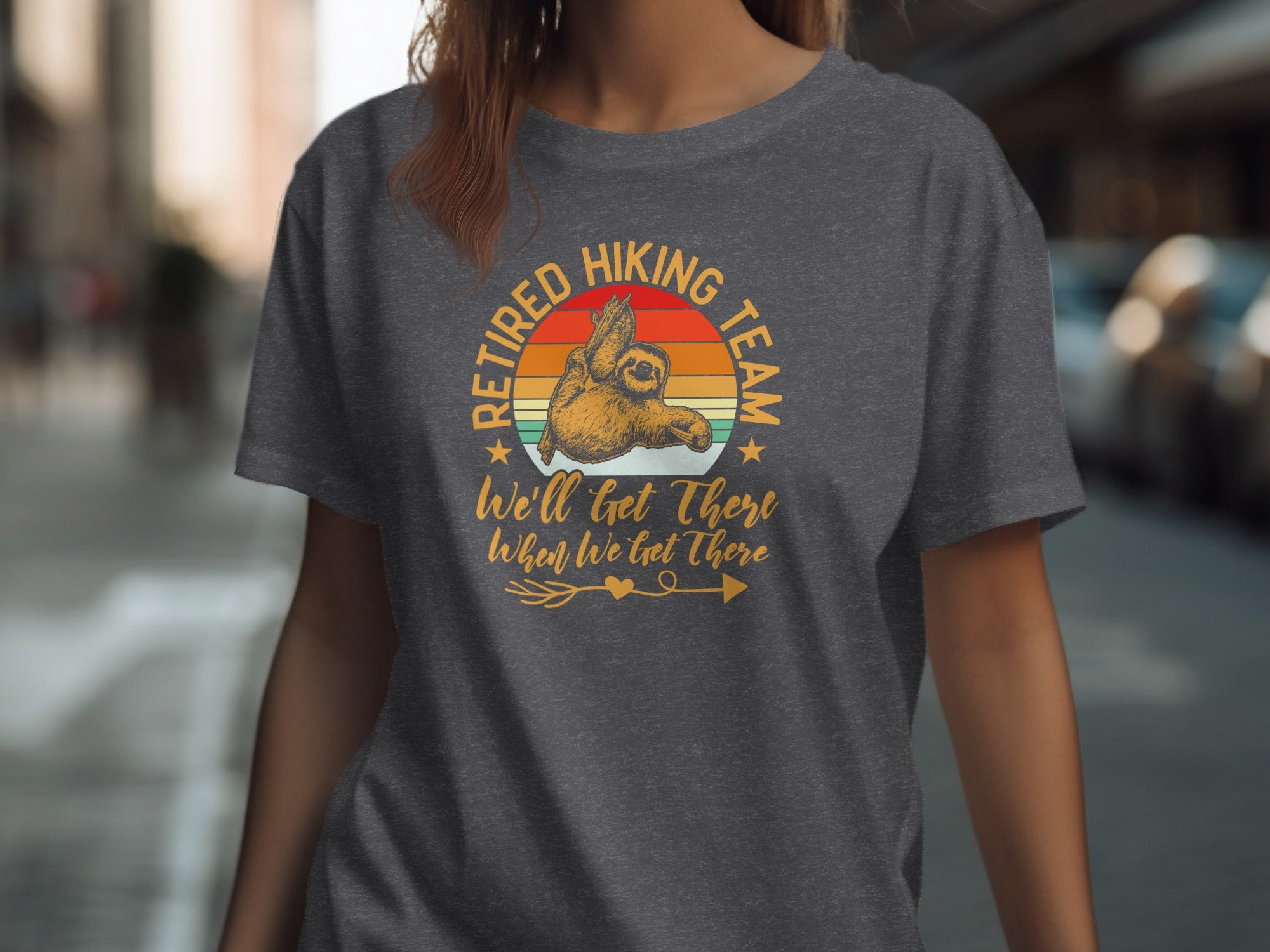 Dark grey t-shirt with a sloth graphic and text saying "Retired Hiking Team".