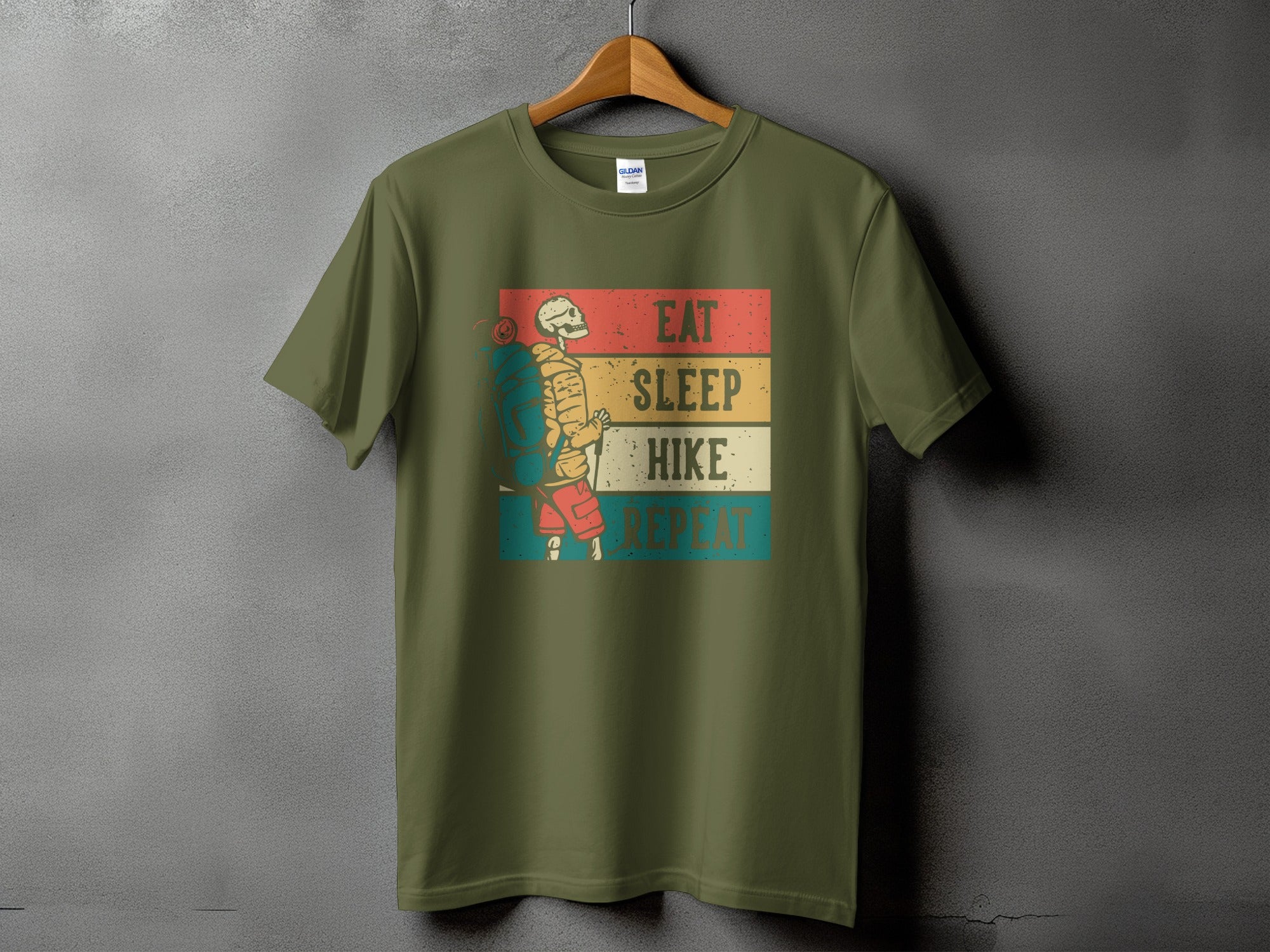 Olive green t-shirt with skeletal hiker graphic and "Eat Sleep Hike Repeat" text.