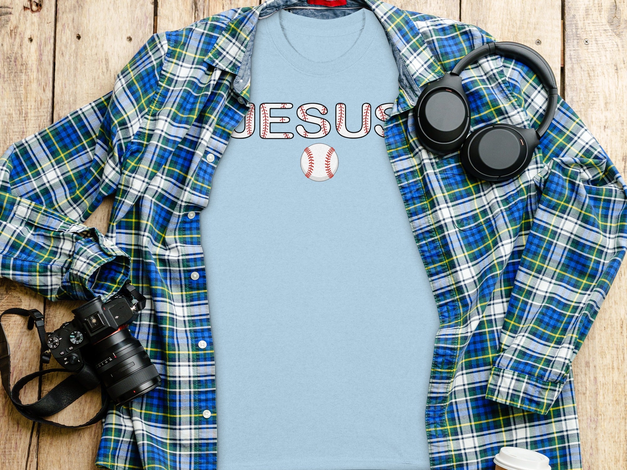 Light blue t-shirt with "JESUS" in baseball stitching and a baseball graphic.