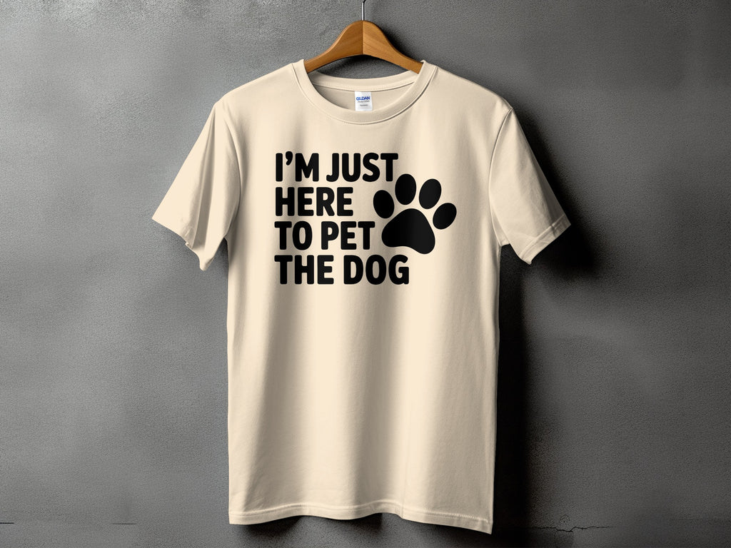 Cream t-shirt with black text "I'M JUST HERE TO PET THE DOG" and paw print.