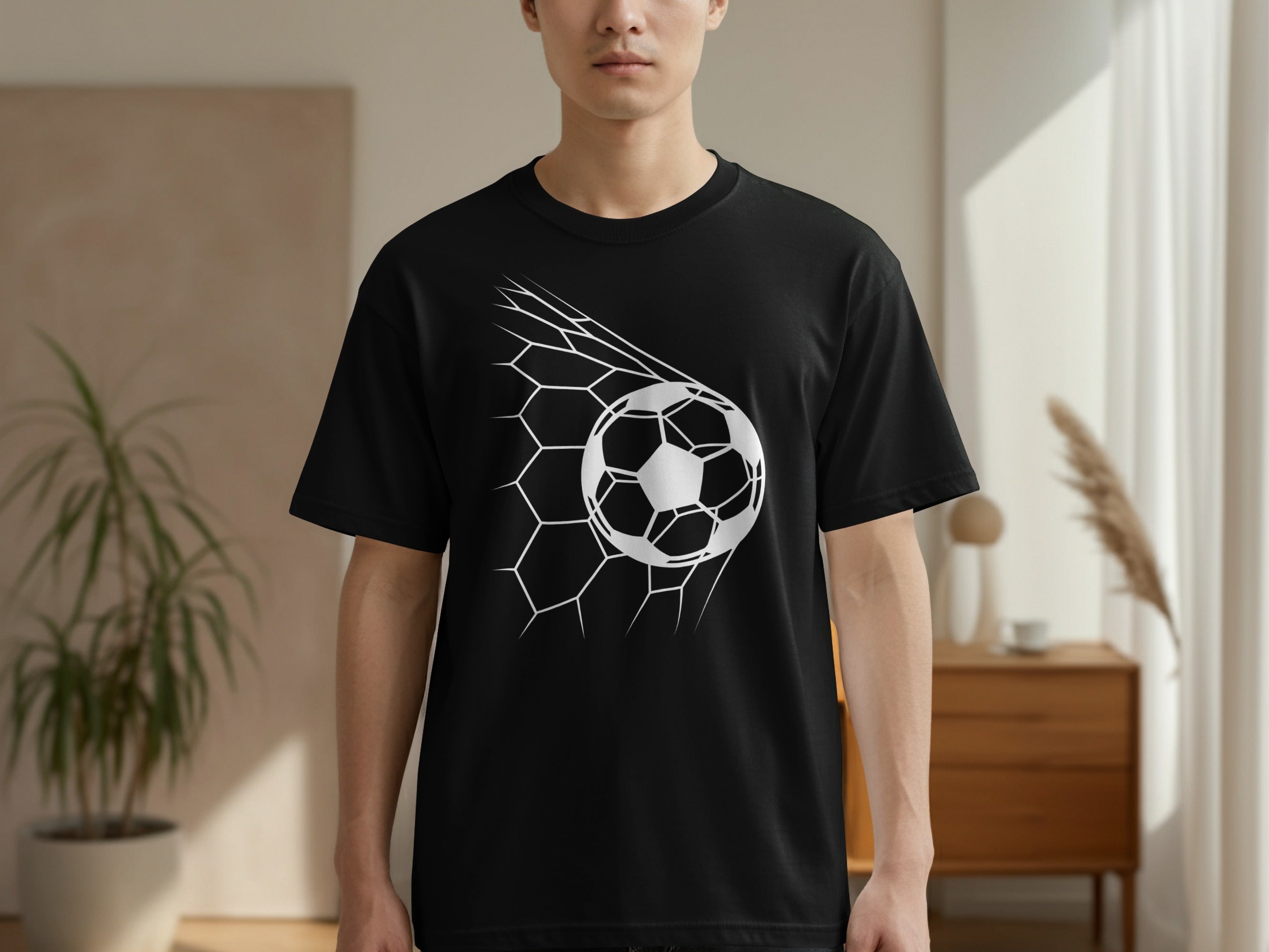 Black t-shirt with white soccer ball graphic in a net.