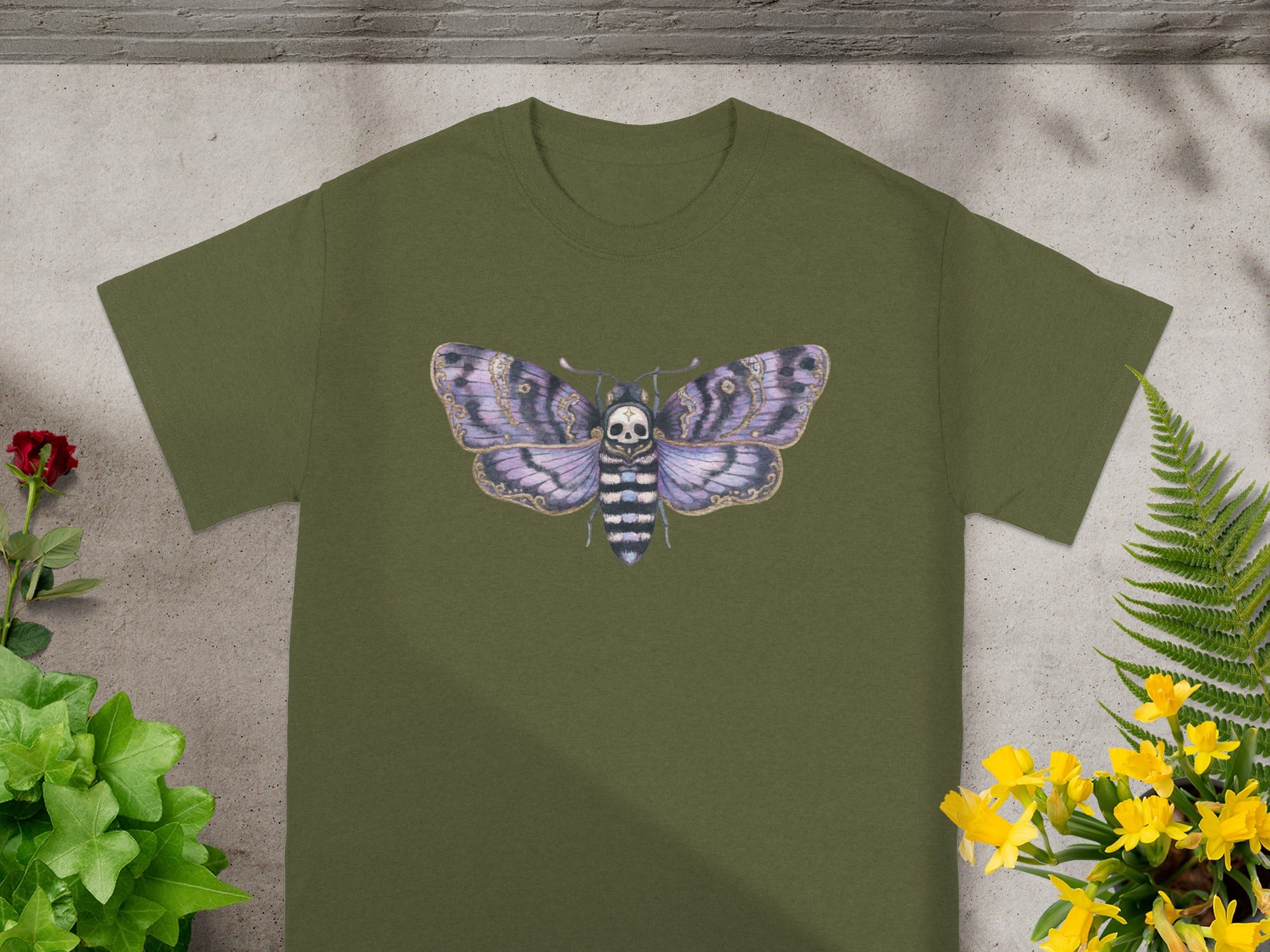 Olive green t-shirt with a purple and black moth skull design.