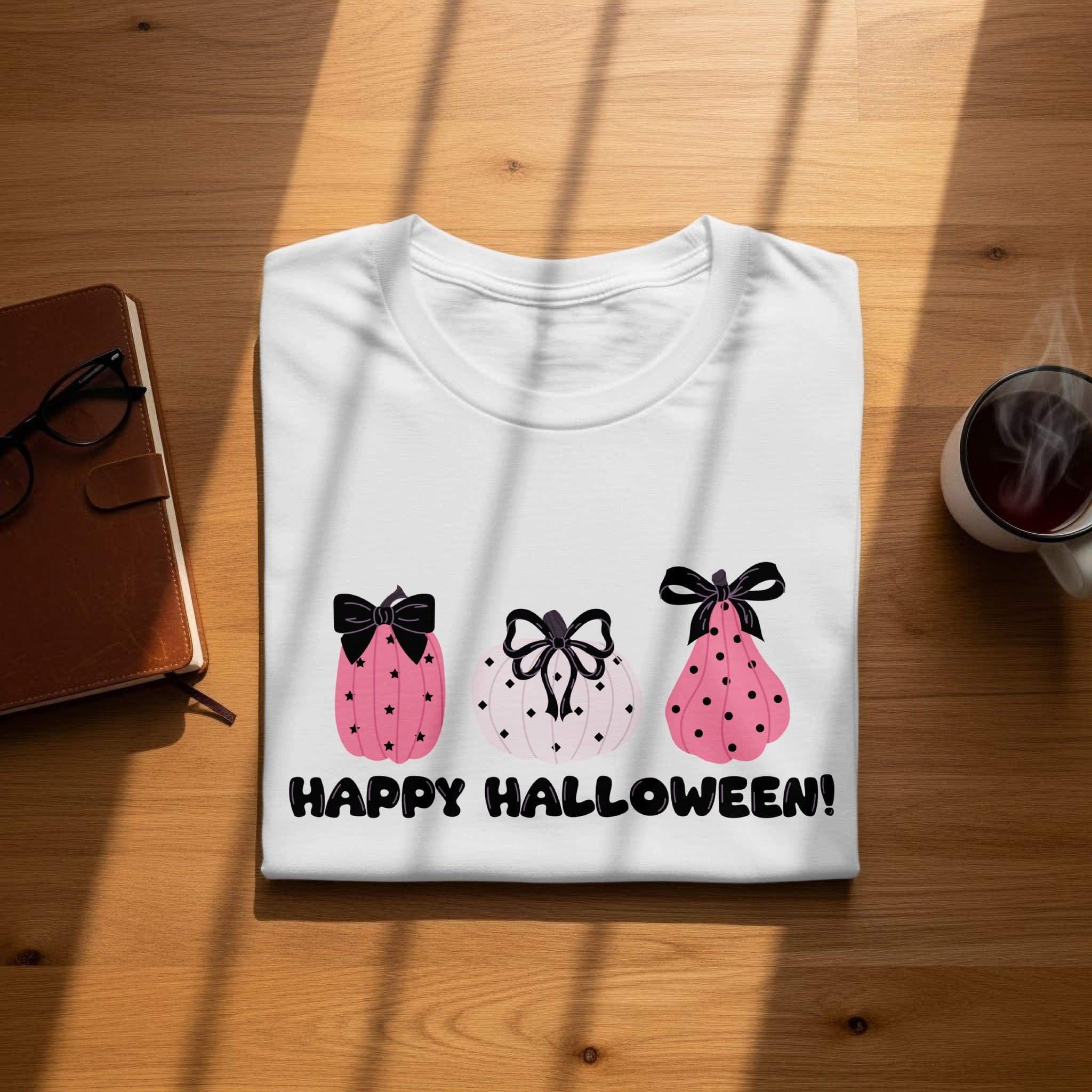White t-shirt with three pink pumpkins and "HAPPY HALLOWEEN!" text.