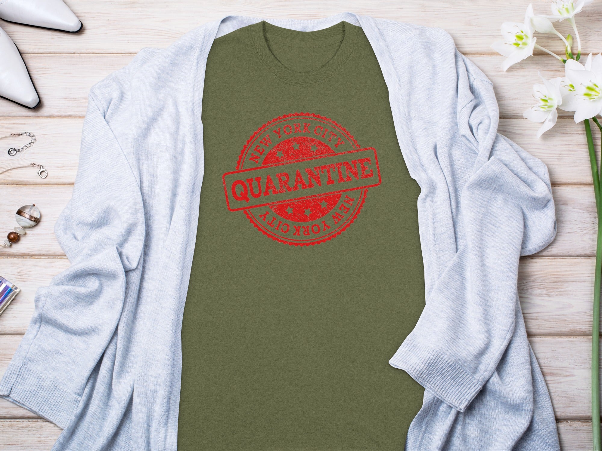 Olive green t-shirt with red New York City Quarantine stamp graphic.