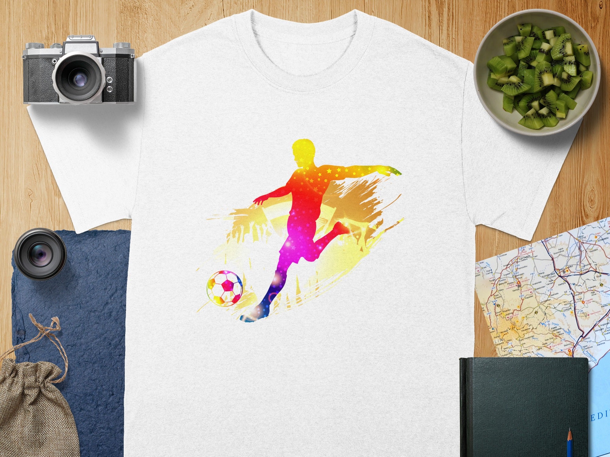 White t-shirt with colorful gradient soccer player kicking ball design.