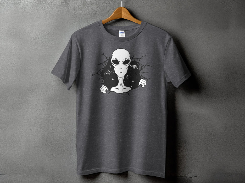 Dark grey t-shirt with graphic of alien bursting through cracked wall with planets.