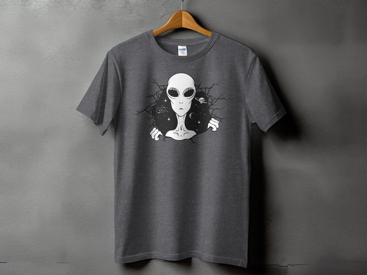 Dark grey t-shirt with graphic of alien bursting through cracked wall with planets.