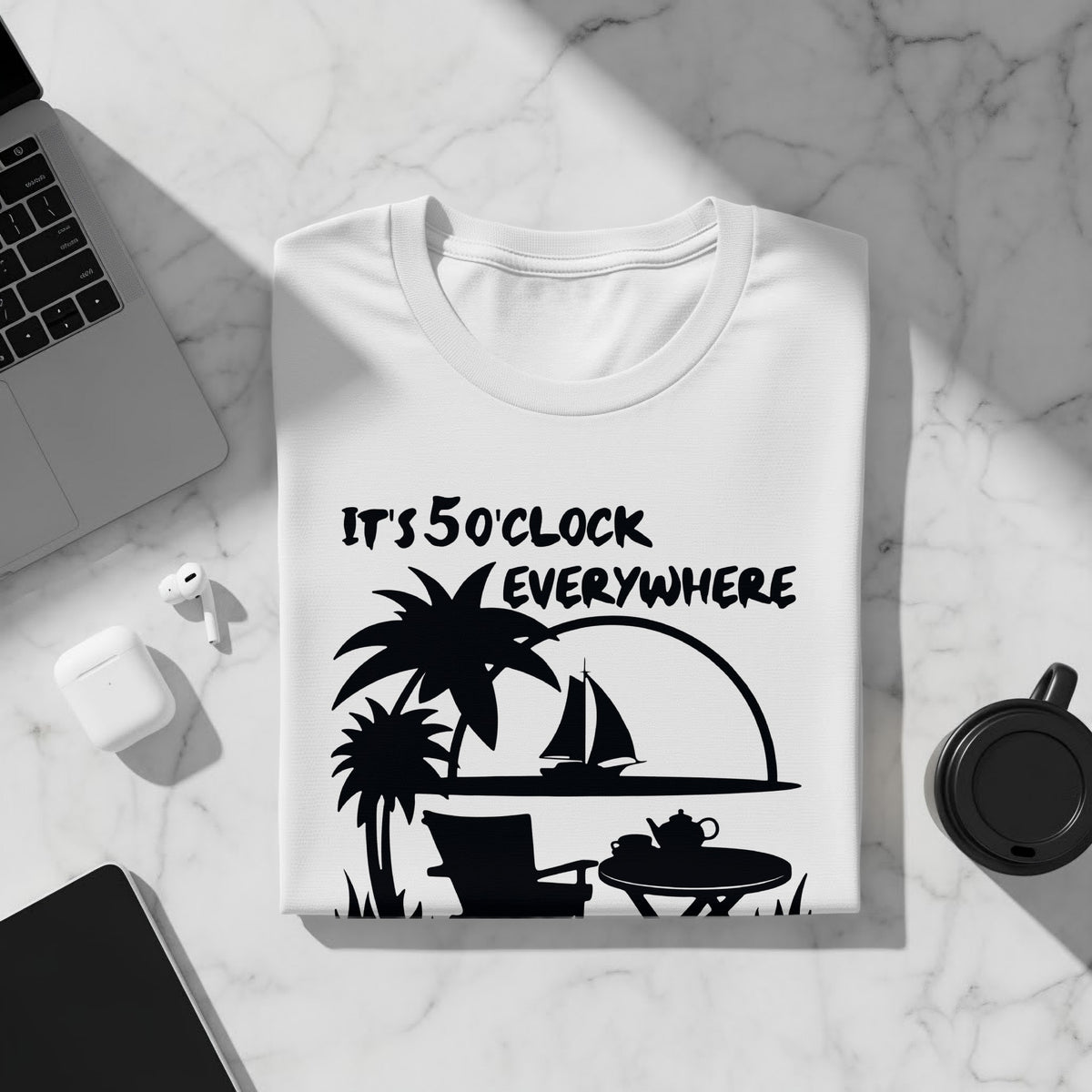 White t-shirt with black graphic saying "It's 5 o'clock everywhere" and beach scene.