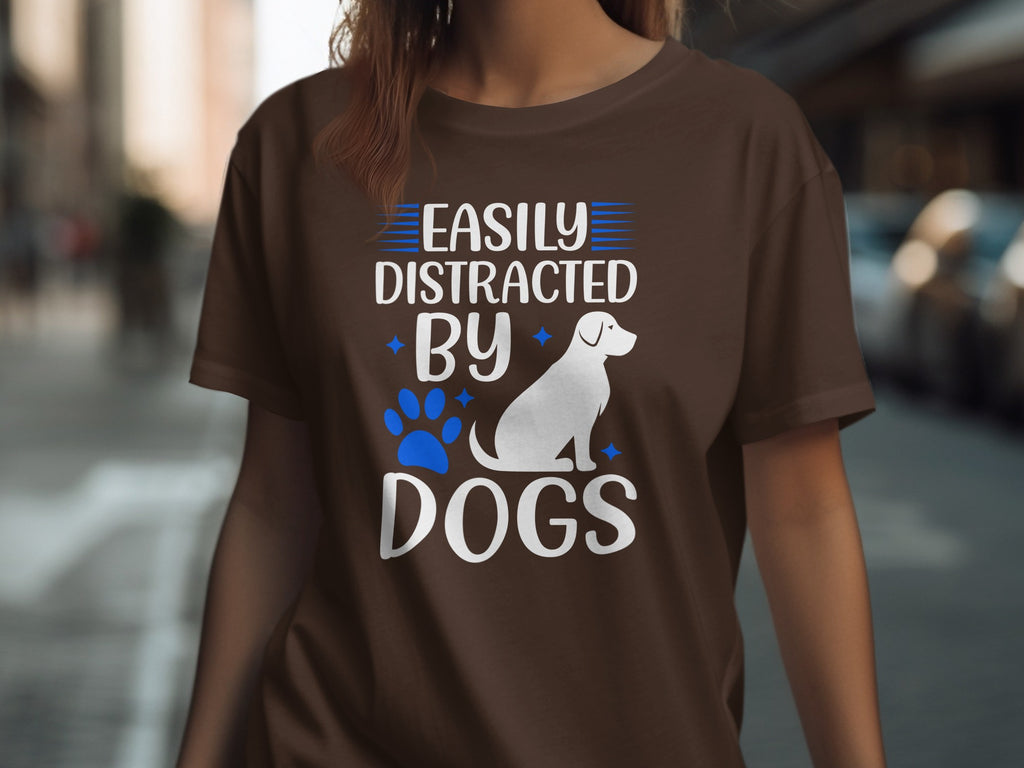 Brown t-shirt with white text and dog graphic: "Easily Distracted By Dogs"