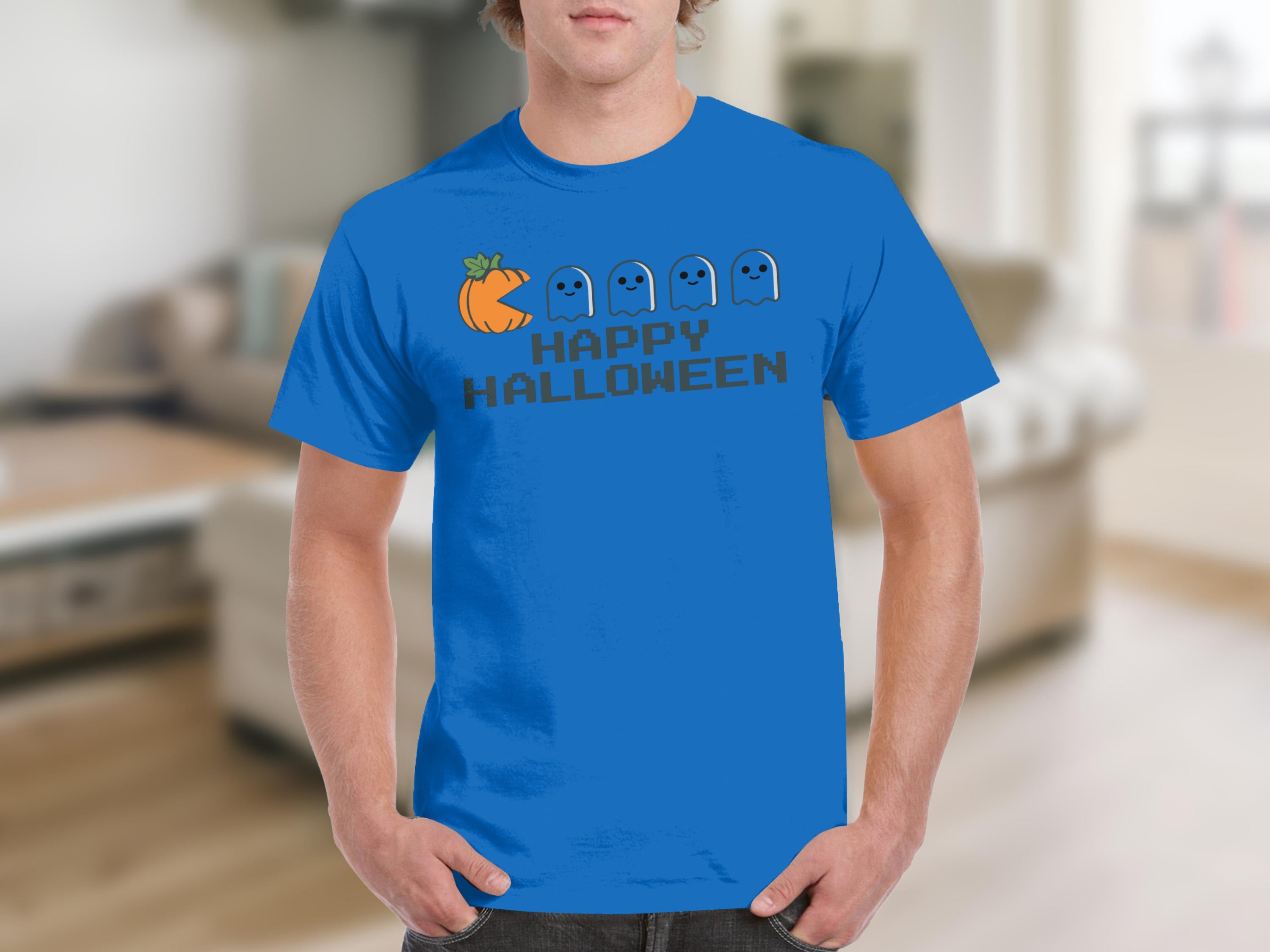 Blue t-shirt with graphic ofPac-Man pumpkin chasing ghosts and text "Happy Halloween".