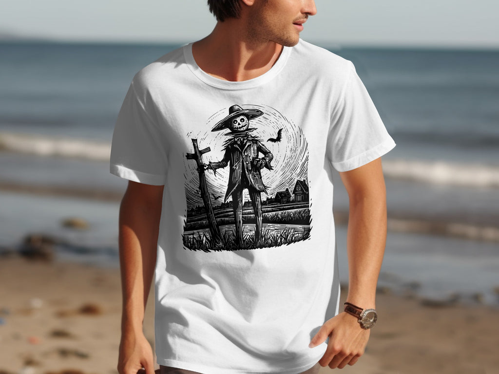 White t-shirt with black ink illustration of a scarecrow and a bat.