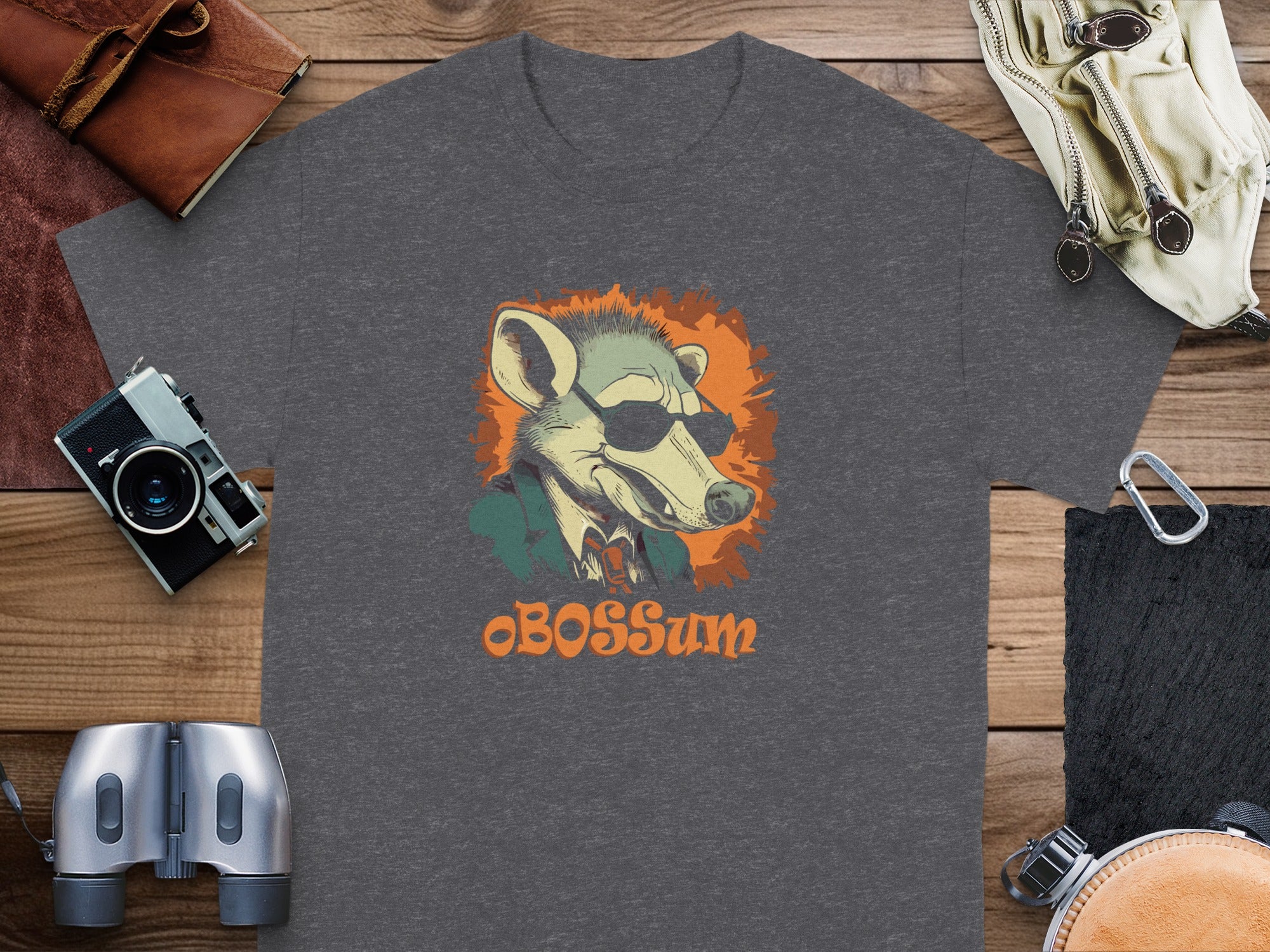 Dark grey t-shirt with a graphic of a possum wearing sunglasses and a suit, text reads "BOSSsum".
