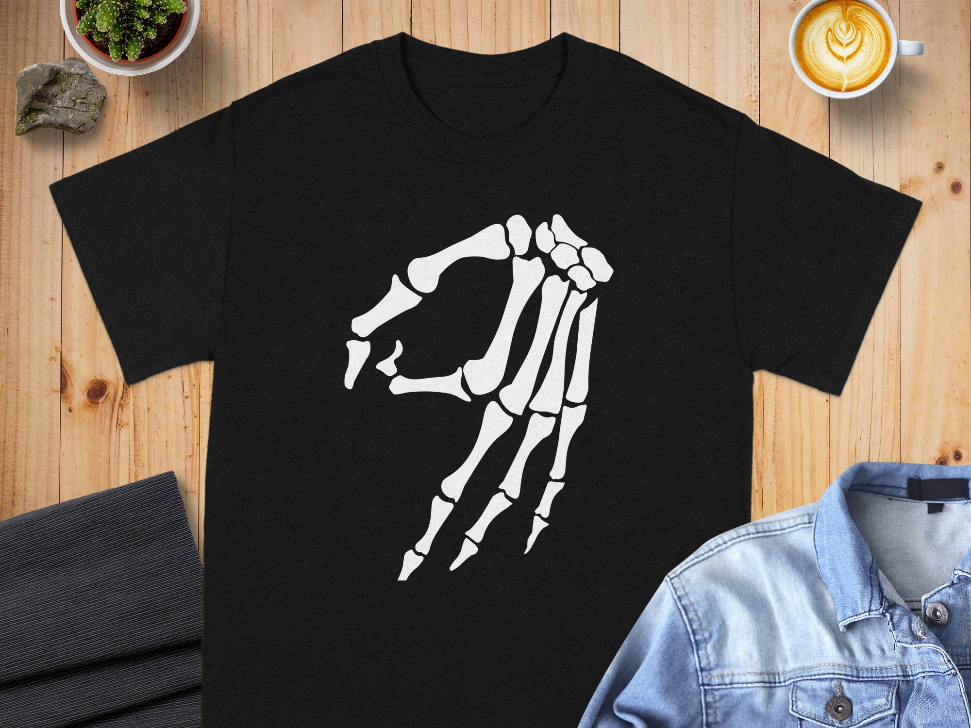 Black t-shirt with white skeleton hand making the "okay" gesture.
