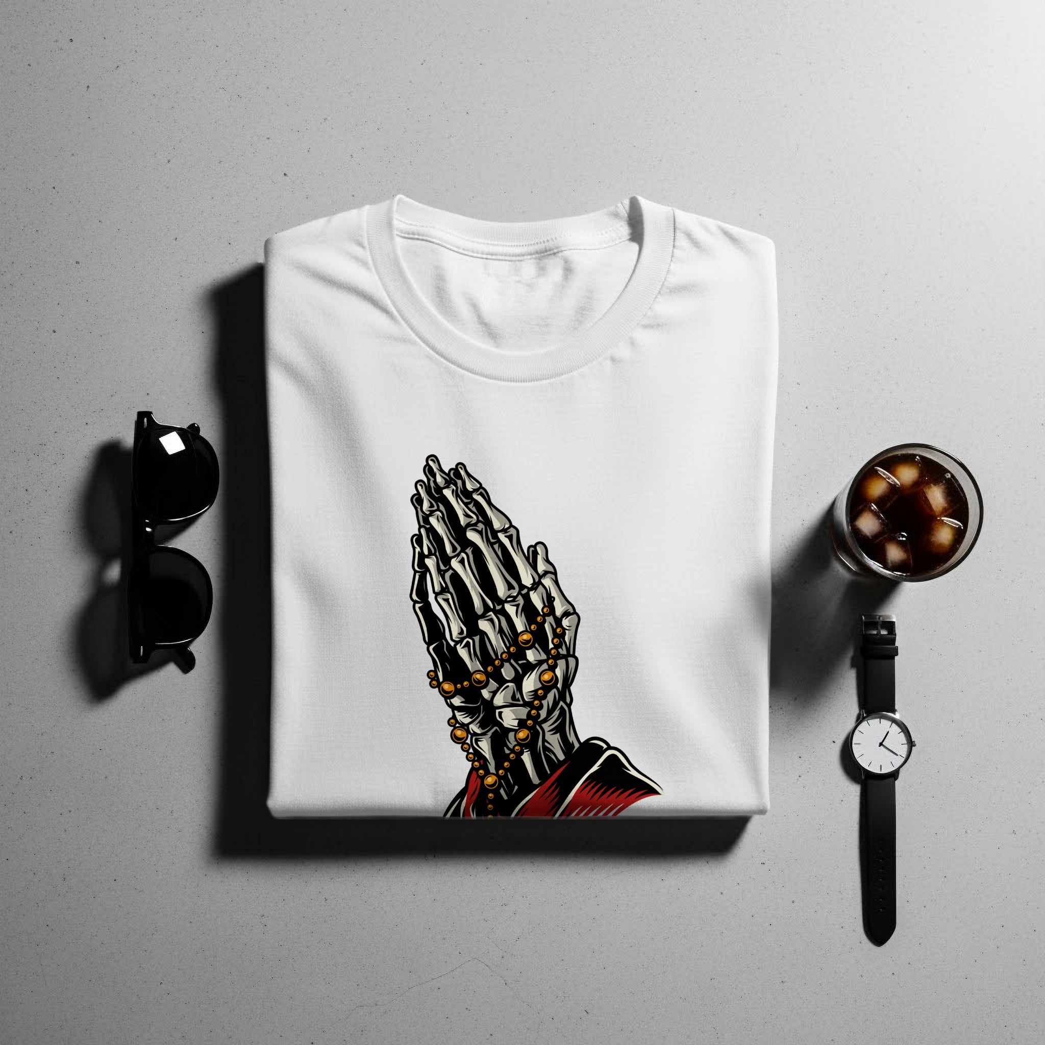 White t-shirt with skeleton praying hands graphic and beaded necklace.