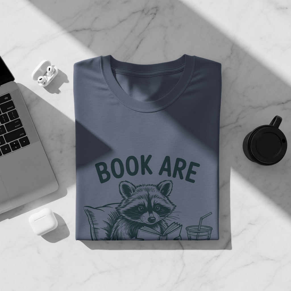 T-shirt with raccoon reading a book and the text "BOOK ARE"