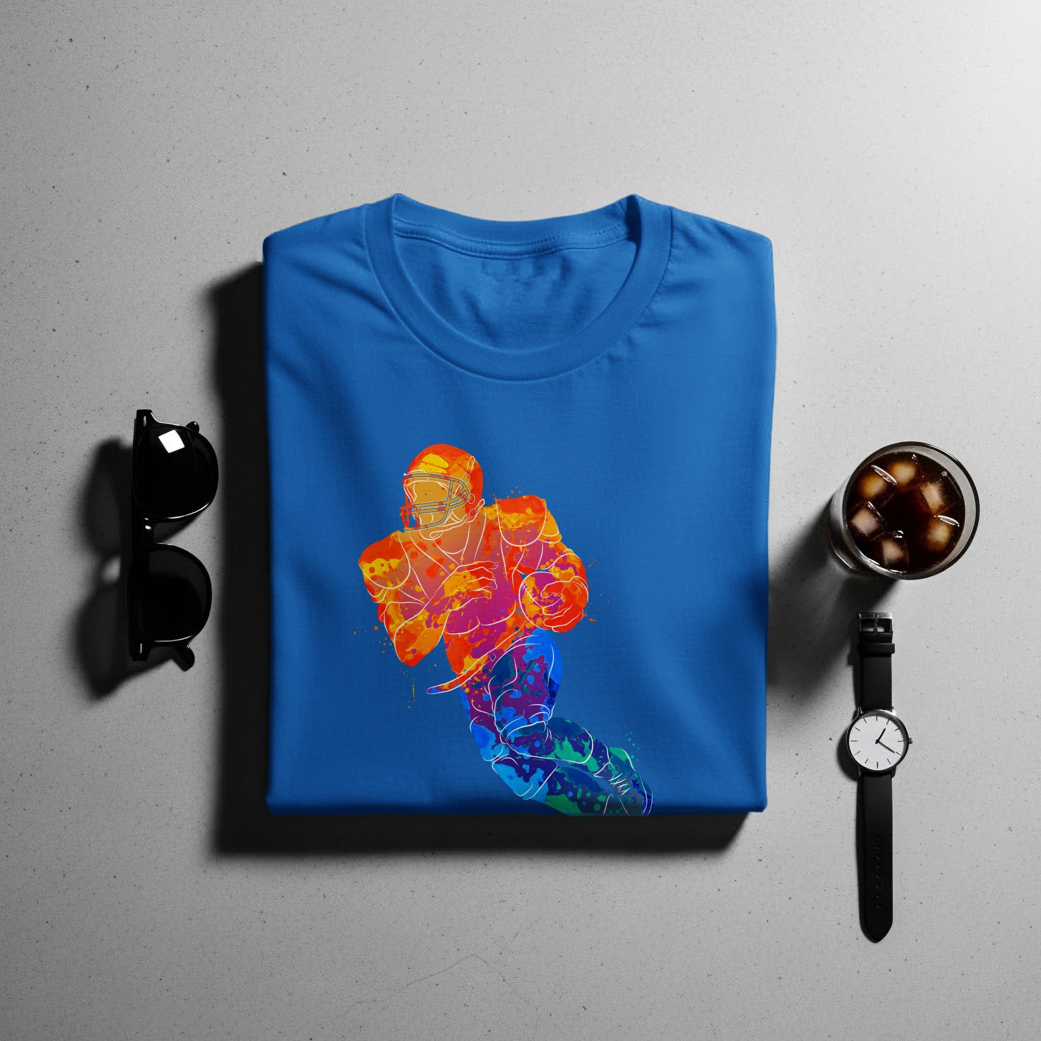 Blue t-shirt with a colorful watercolor football player graphic.
