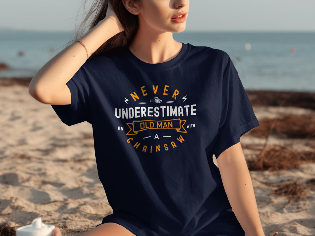 Navy t-shirt with text "Never underestimate an old man with a chainsaw"