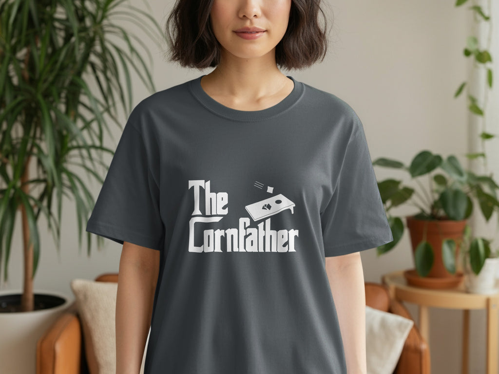 Dark grey t-shirt with white "The Cornfather" text and cornhole graphic.