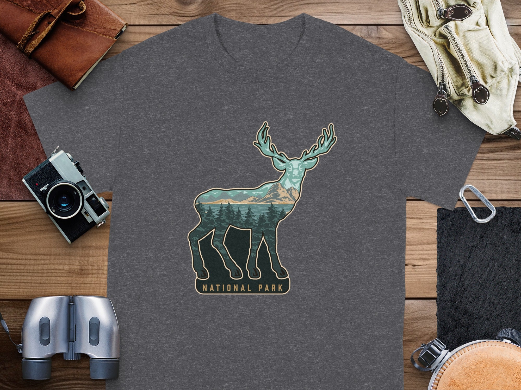 Deer silhouette filled with trees and mountains, text National Park.
