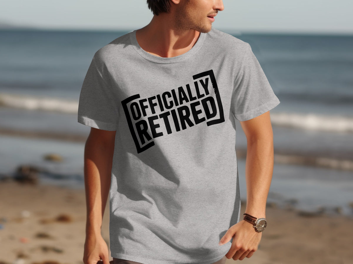 Grey t-shirt on man with black text "OFFICIALLY RETIRED" on the front.