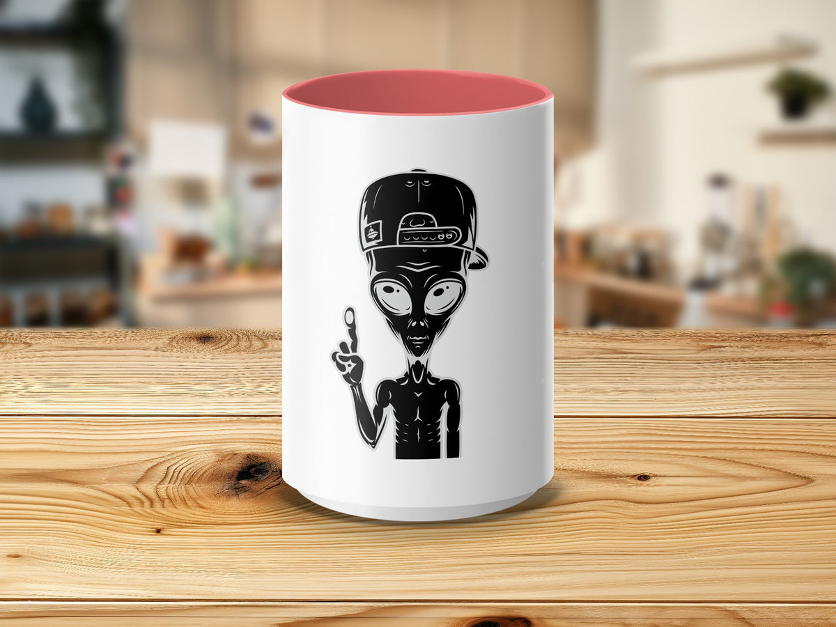 White mug with red interior featuring a black alien with a backward baseball cap.
