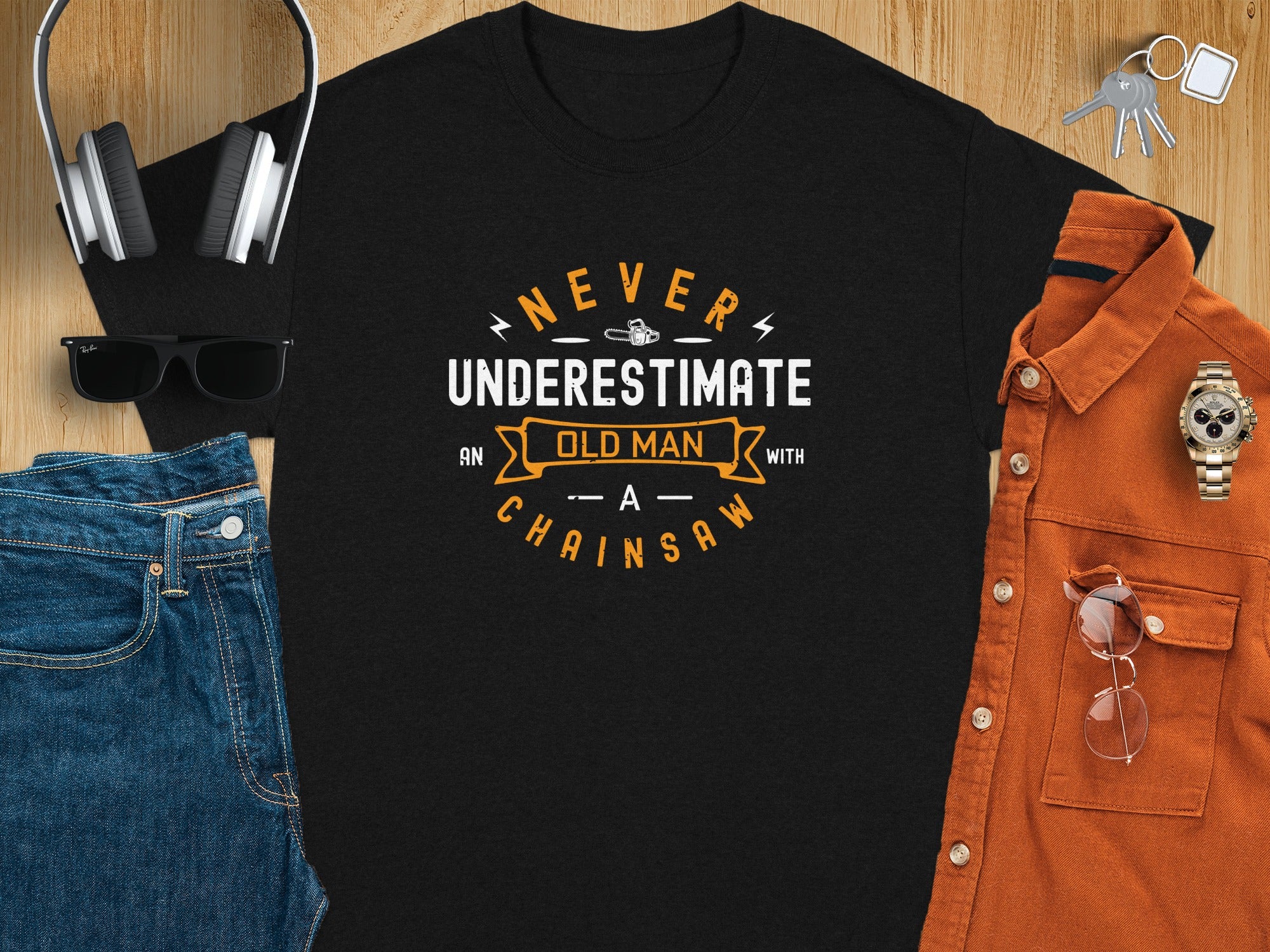 Black t-shirt with "Never Underestimate Old Man With A Chainsaw" text design.