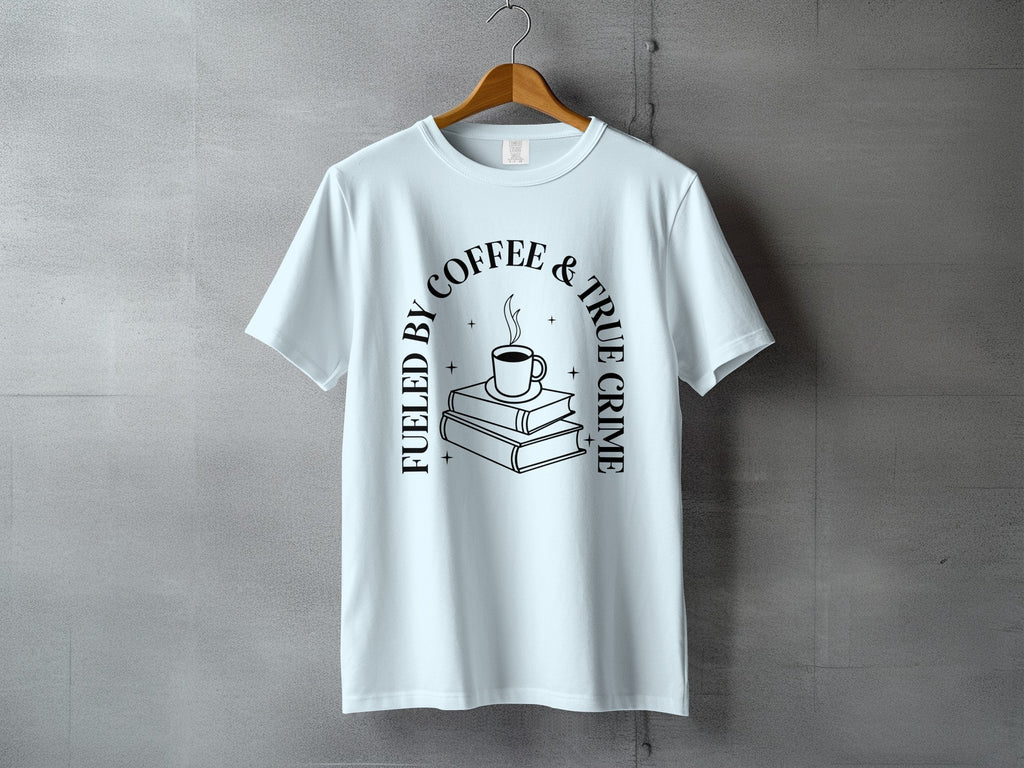 Light blue t-shirt with "Fueled by Coffee & True Crime" text and stack of books graphic.