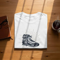 White t-shirt with a hiking boot graphic and text "Hike More Worry Less."