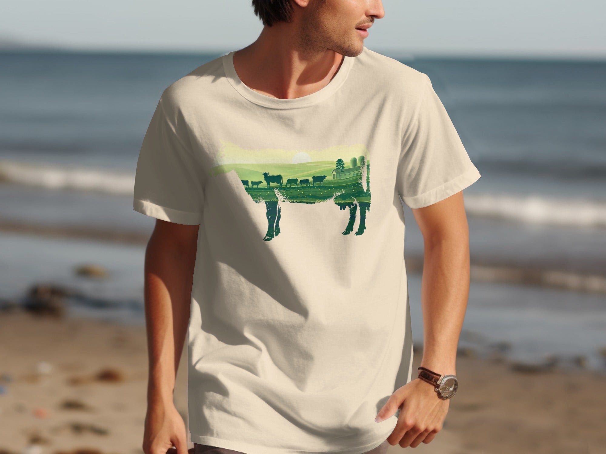 T-shirt with a dark green silhouette of a cow filled with a farm landscape.