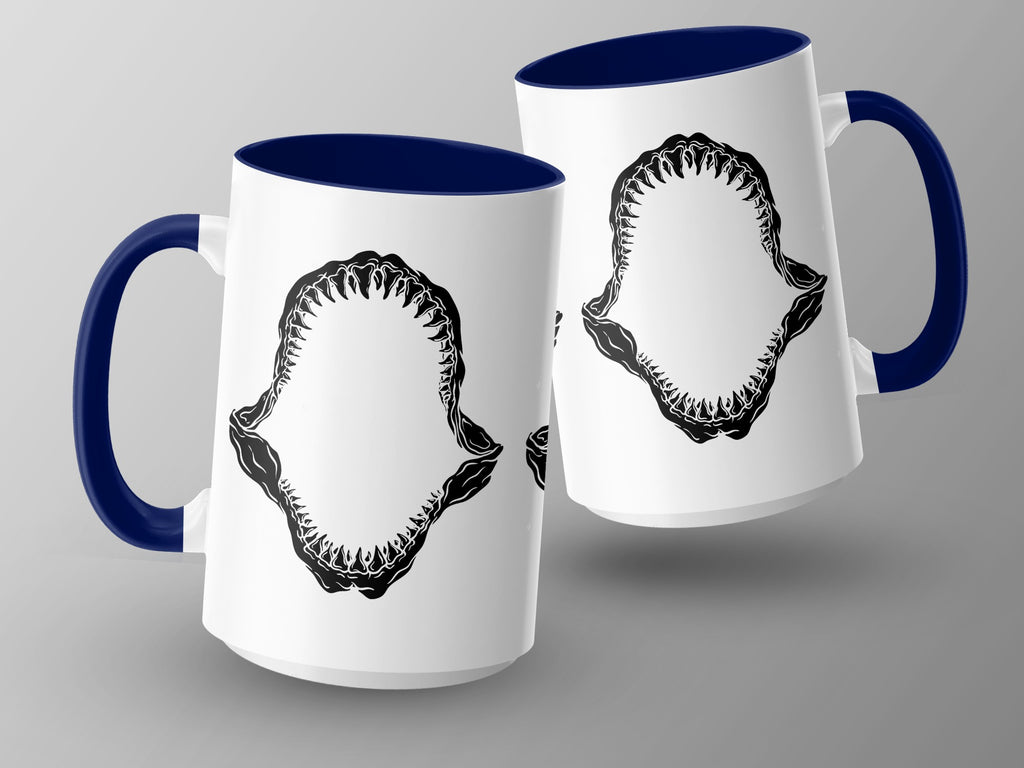 White mugs with dark blue handles and interiors, featuring shark teeth graphic.