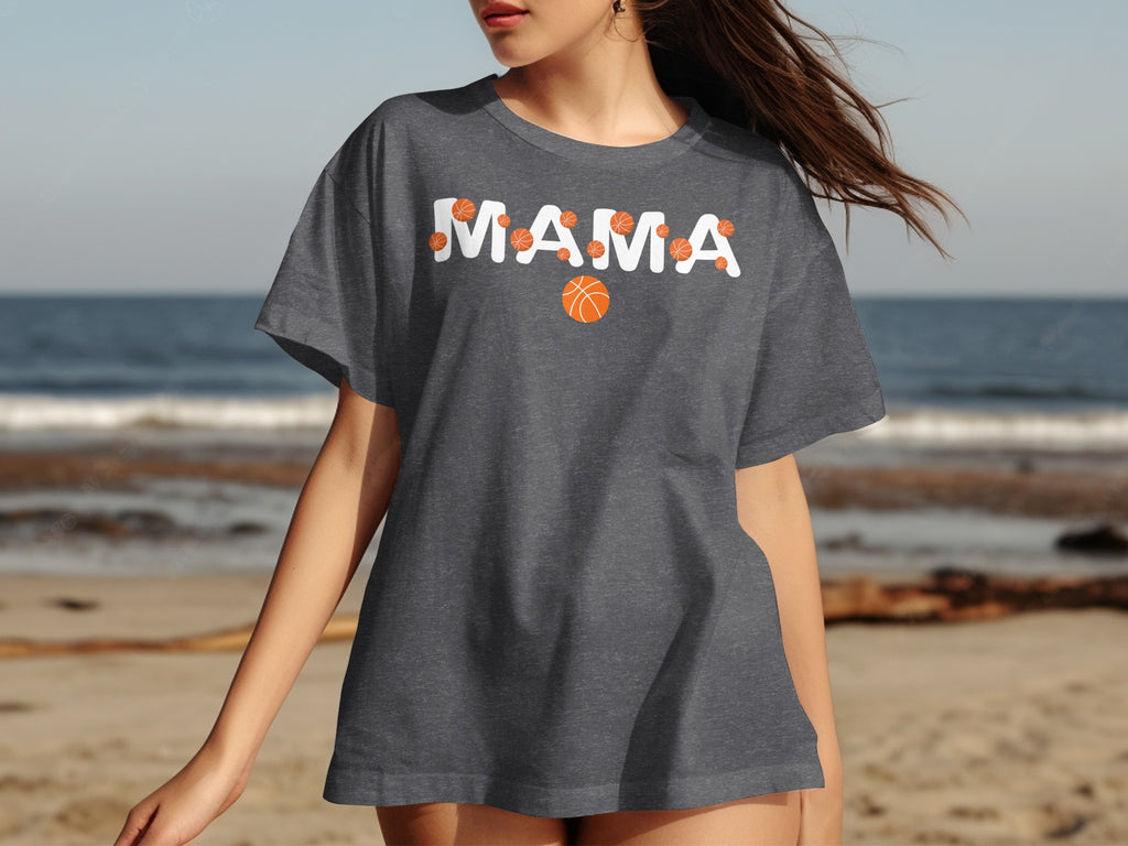 Dark grey t-shirt with "MAMA" text and basketball graphics on a beach.
