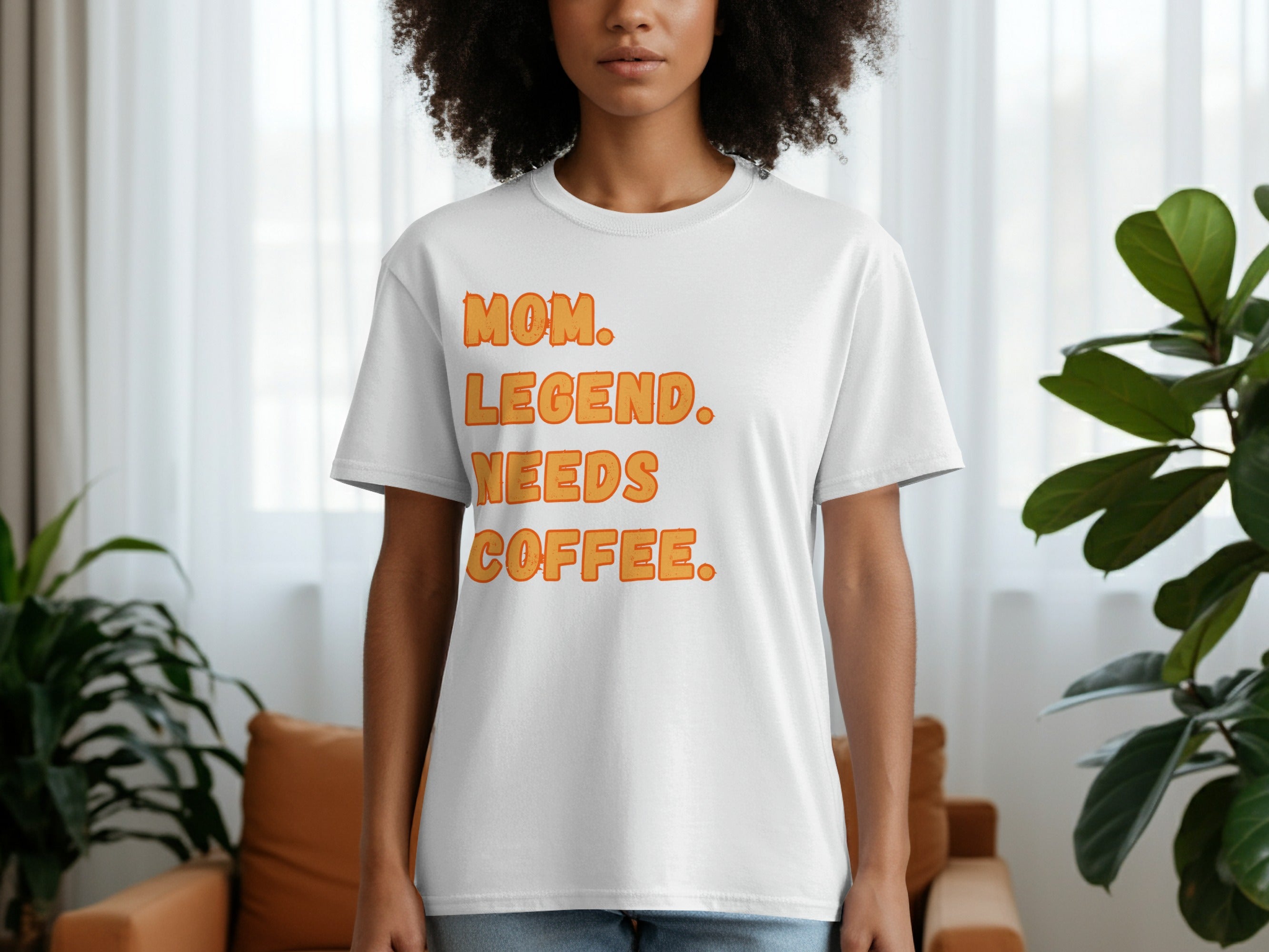 White t-shirt with orange text: "MOM. LEGEND. NEEDS COFFEE."