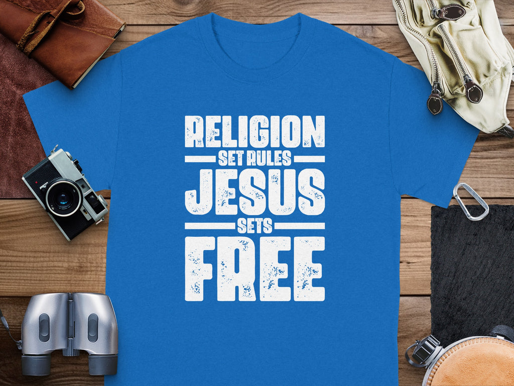 Blue t-shirt with white text reading "Religion set rules Jesus sets free."