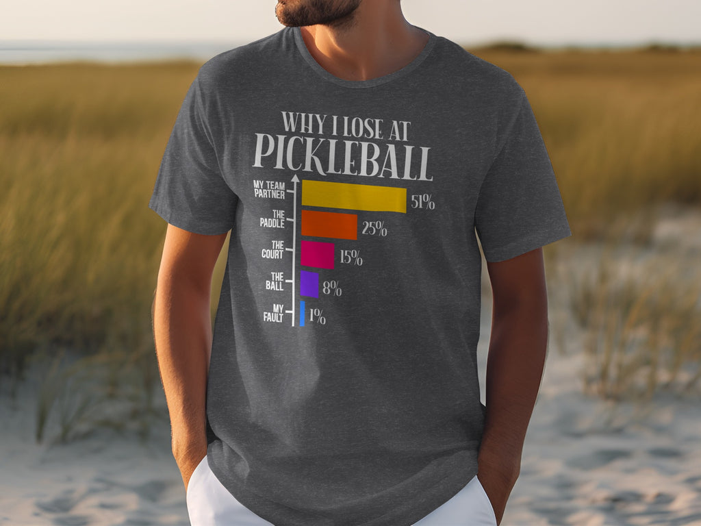 Dark grey t-shirt with "Why I Lose At Pickleball" graphic and bar chart.