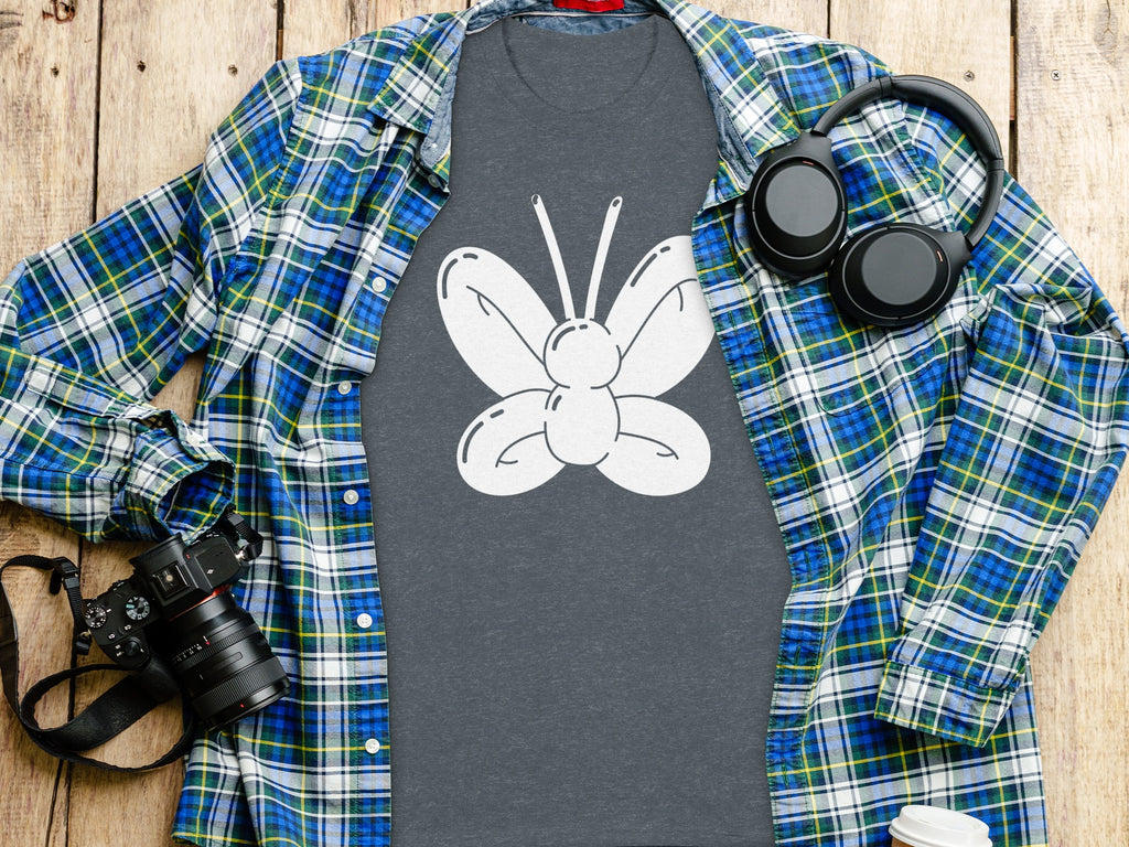 Dark grey t-shirt with white balloon butterfly graphic, green and blue plaid shirt.