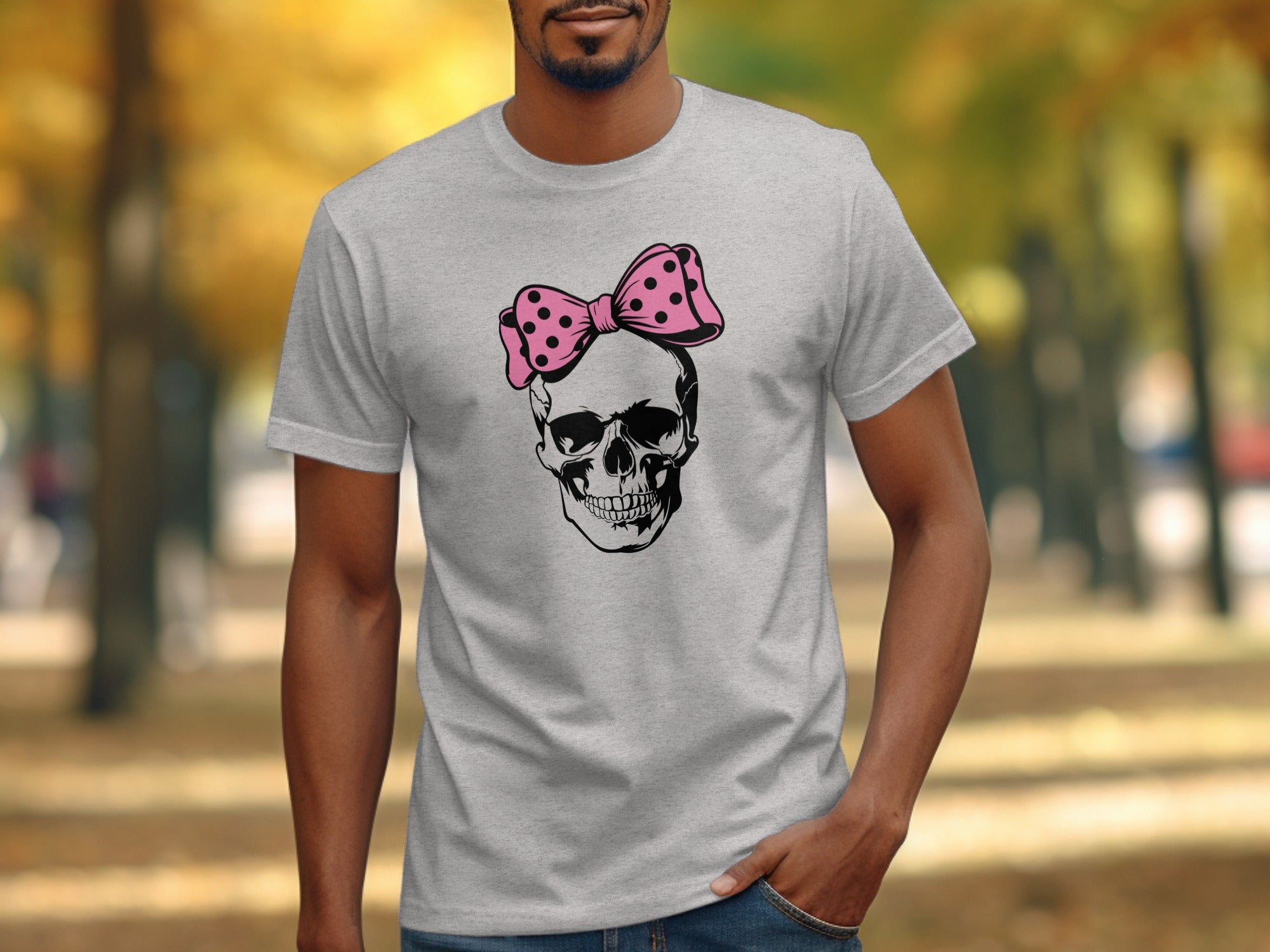 Gray t-shirt with a black skull wearing a pink polka dot bow graphic.