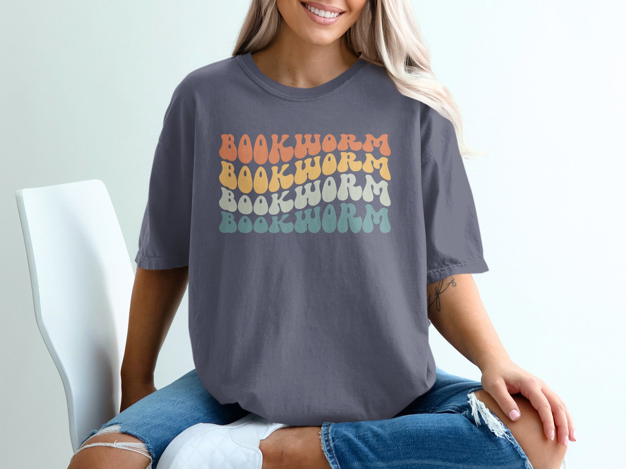 Grey t-shirt with retro wavy "BOOKWORM" text in four color rows.