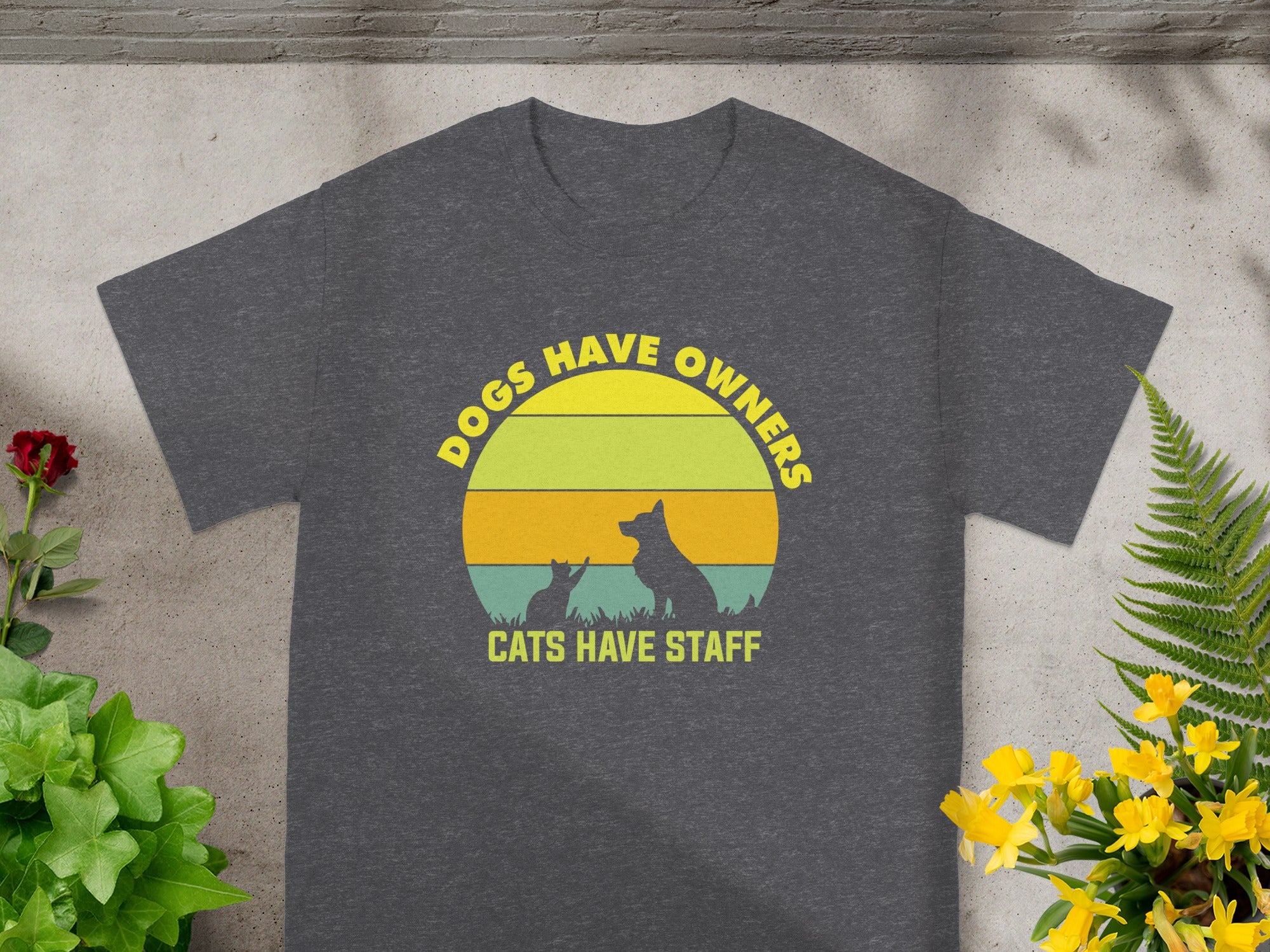 Dark grey t-shirt with text "Dogs Have Owners, Cats Have Staff" and silhouette.