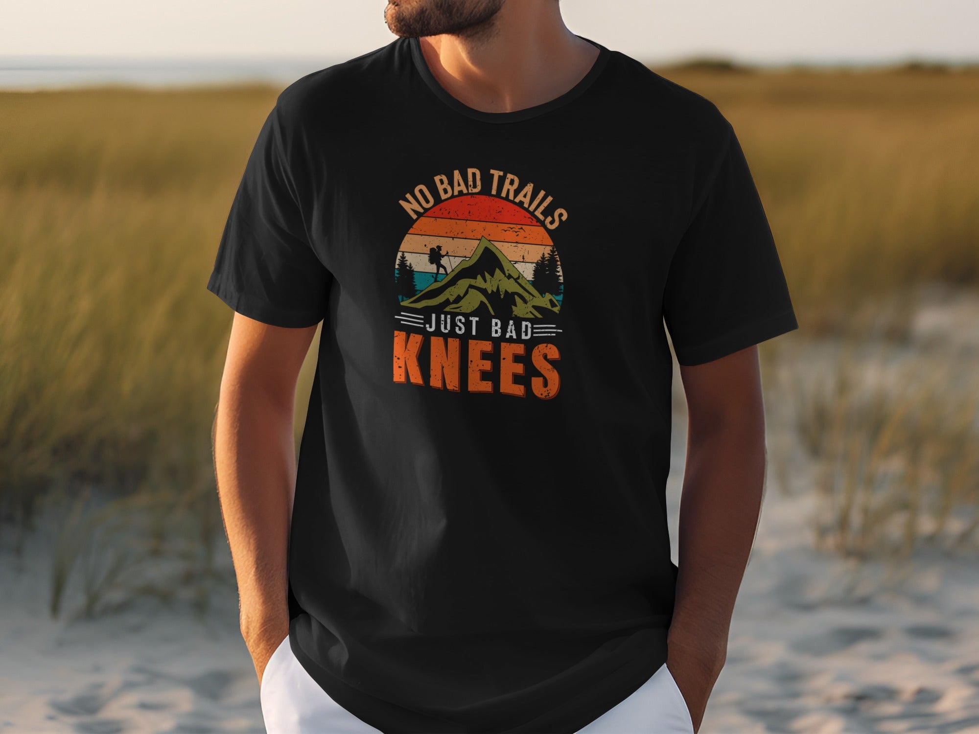 Black t-shirt with "No Bad Trails Just Bad Knees" hiking graphic.