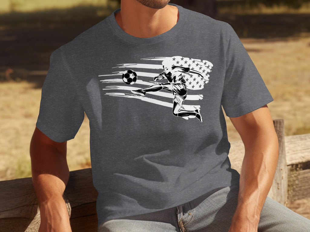 Dark grey t-shirt with a graphic of a soccer player kicking ball over an American flag design.
