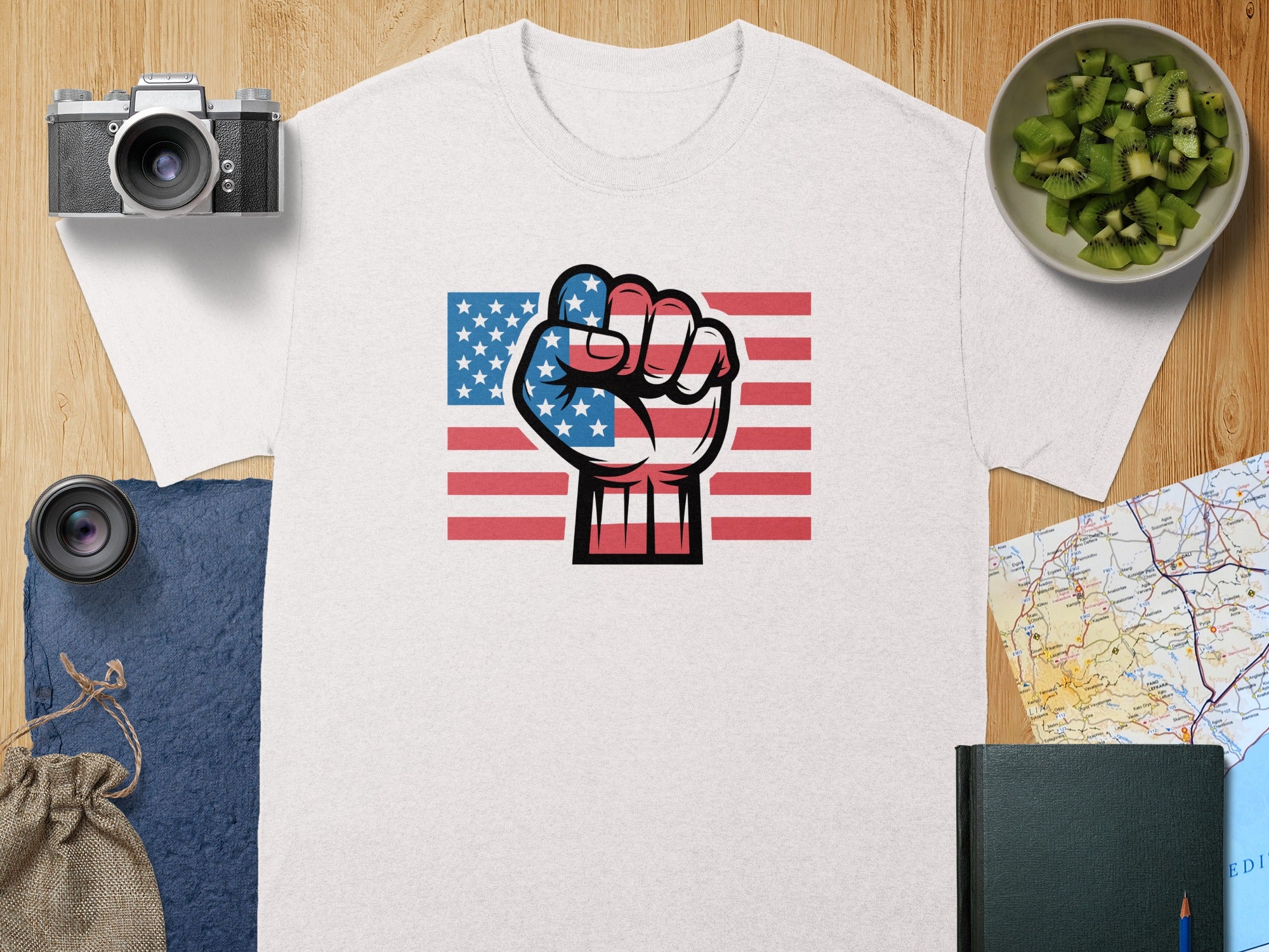 White t-shirt with American flag fist graphic and red stripes.
