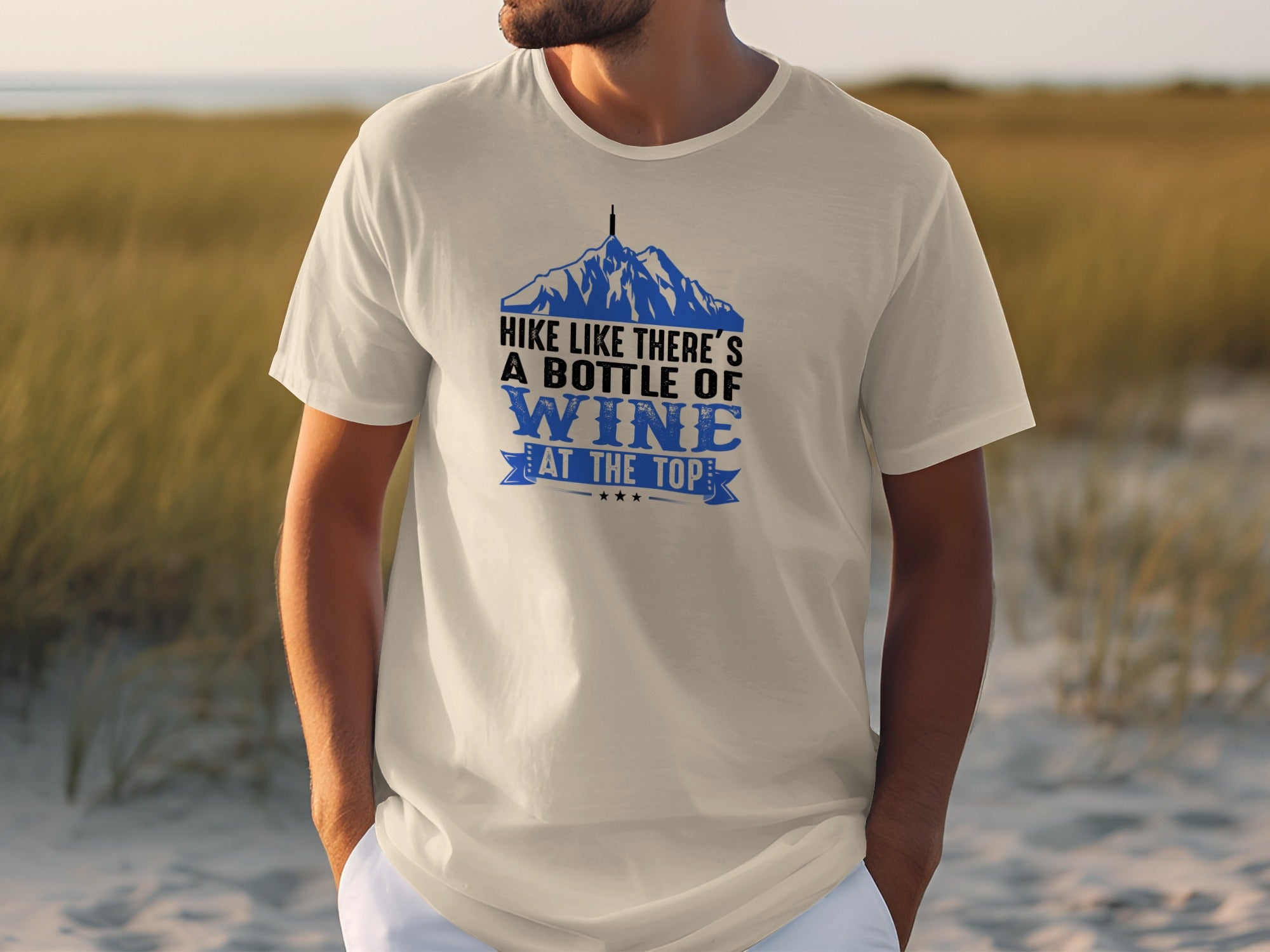 Cream t-shirt with graphic mountains and text: "Hike Like There's A Bottle of Wine At The Top".