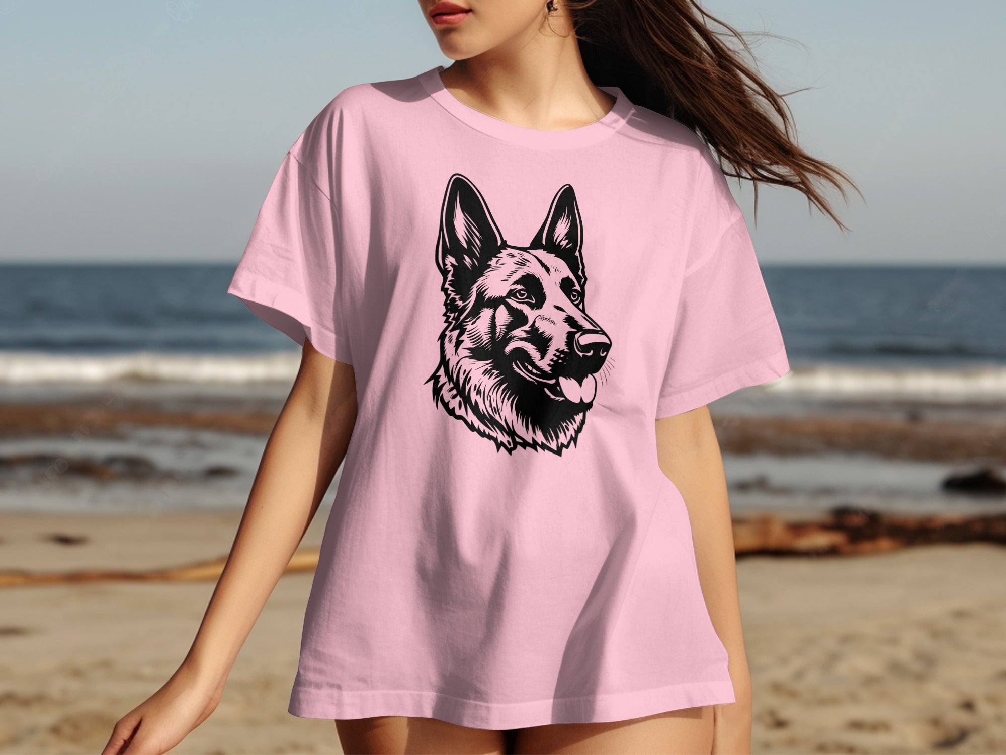 Pink t-shirt with a black graphic of a German Shepherd's head on a beach background.