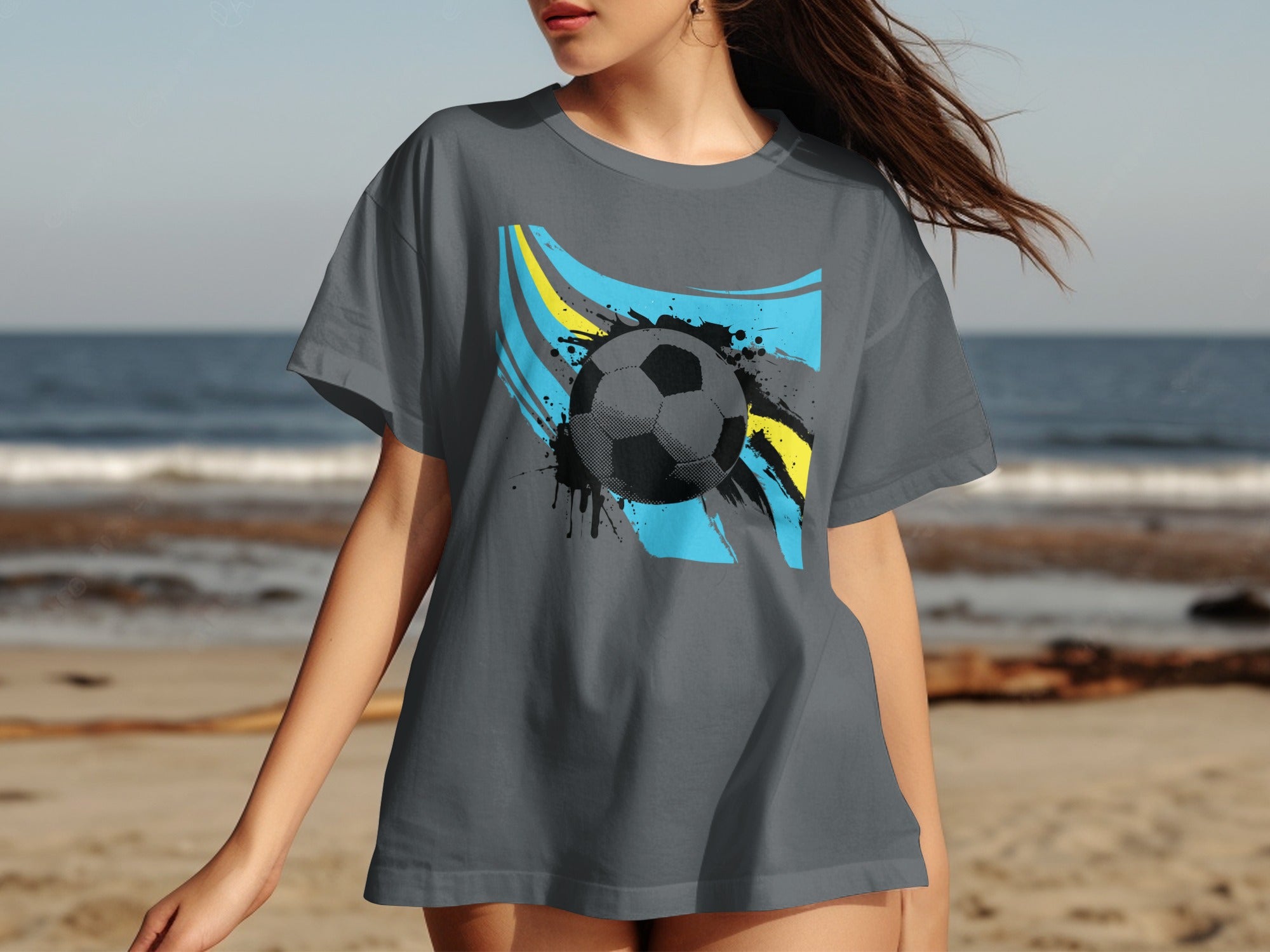 Gray t-shirt with a graphic of a soccer ball and abstract blue and yellow brush strokes.