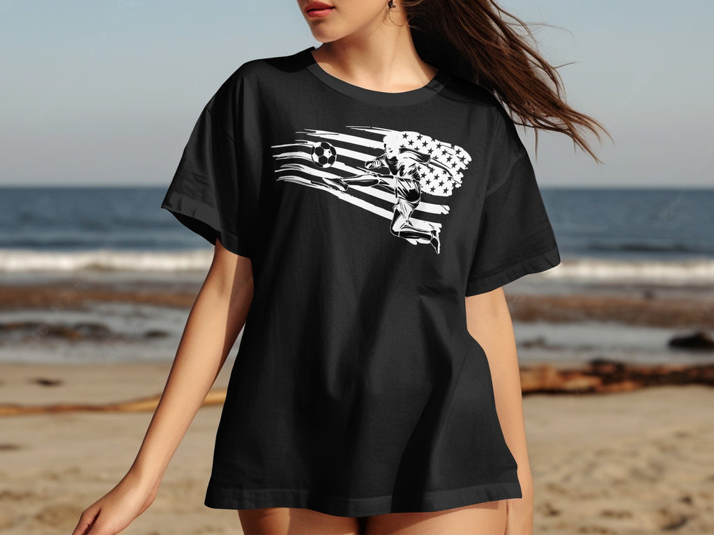 Black t-shirt with a white graphic of a soccer player kicking a ball against an American flag.