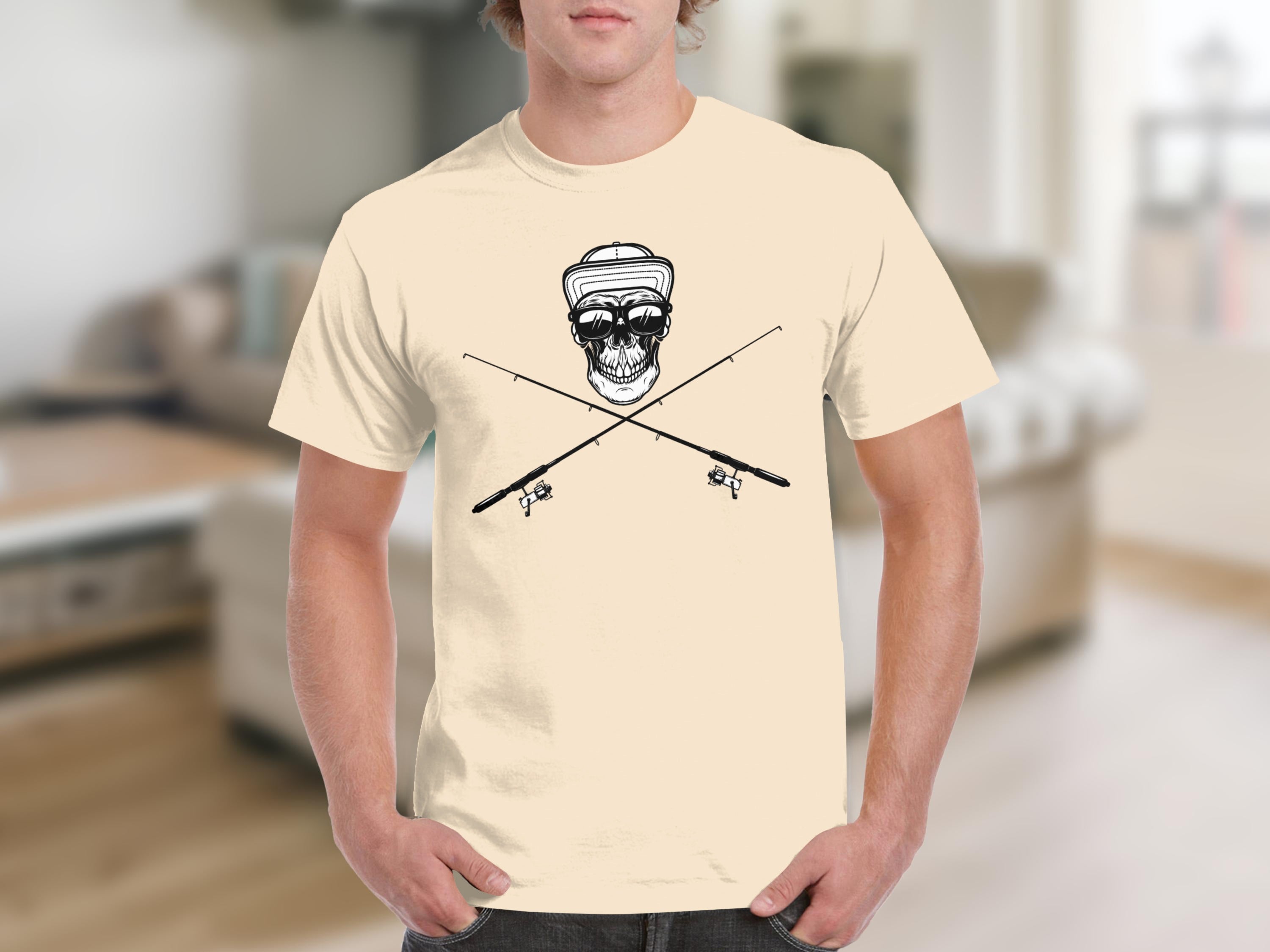 Skull wearing sunglasses and hat with crossed fishing rods graphic on tan t-shirt.