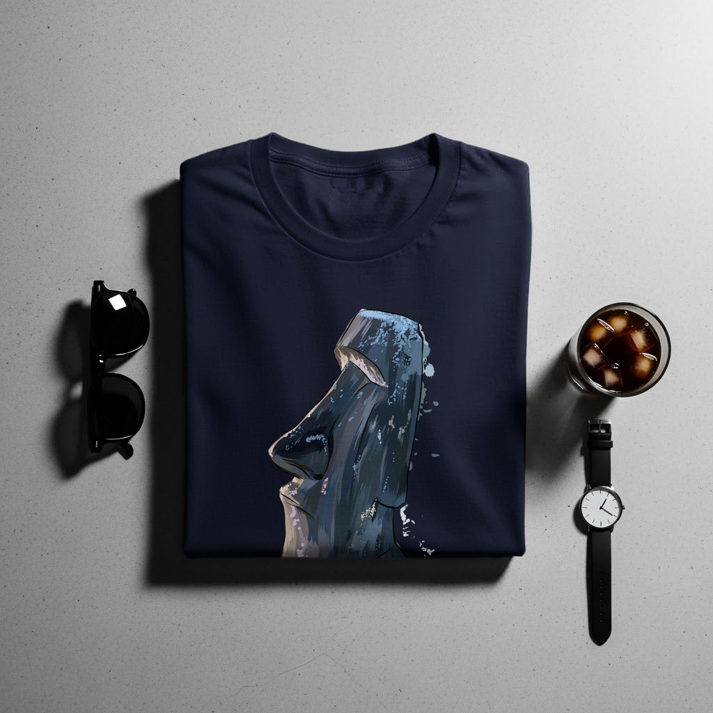 Navy t-shirt with a graphic of a Moai statue head, with sunglasses, watch, and drink.