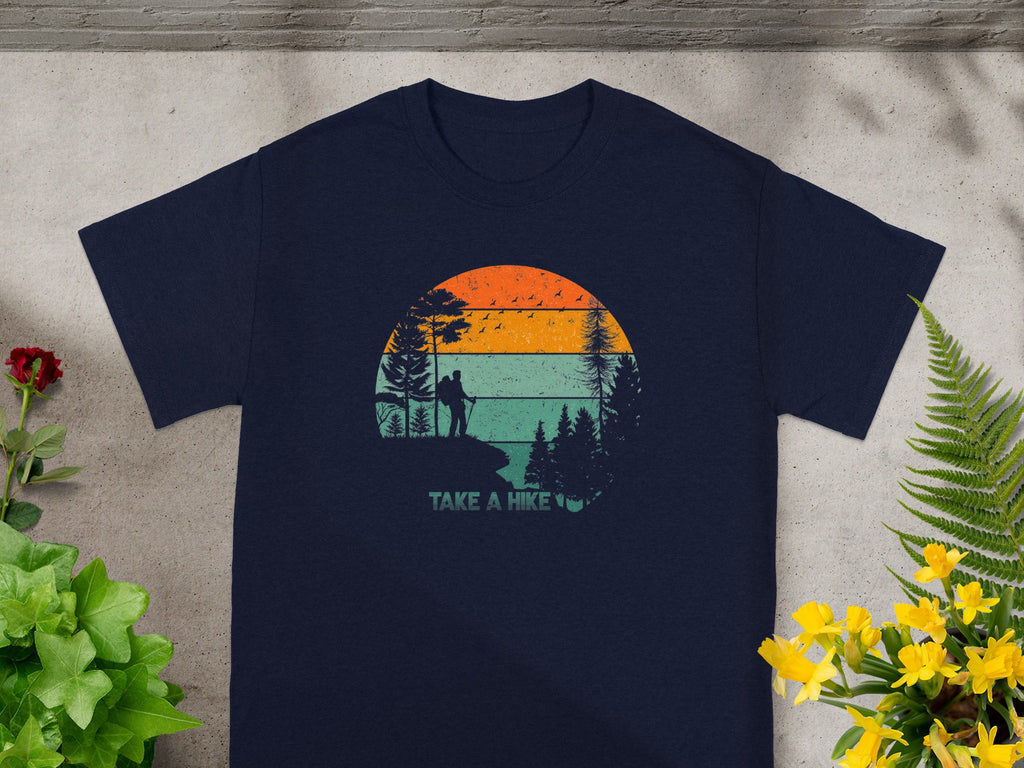 Navy t-shirt with a graphic of a hiker on a cliff under a retro sunset.
