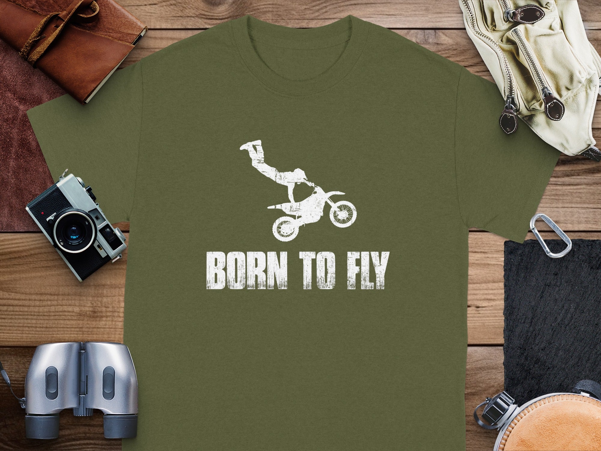 Green t-shirt with white distressed graphic of a dirt bike rider and text "BORN TO FLY".